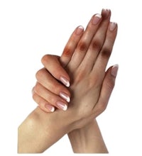 a woman's hands with white nails on a white background